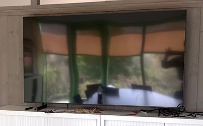 a flat screen tv sitting on top of a white entertainment center