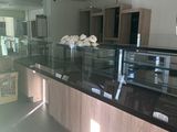 an image of a kitchen with a counter and a glass display case