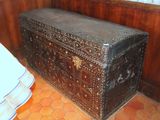 an old trunk sitting in the corner of a room