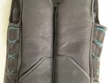 the back of a gray vest with blue stitching on it
