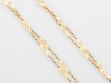 a pair of gold chains on a white background