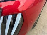 a close up of the front of a red car