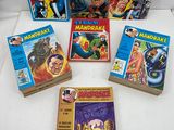 a collection of comic books on a white surface