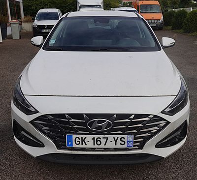 a white car that is parked in a parking lot
