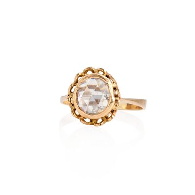 a gold ring with a white diamond in the center