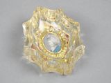 gold plated ring with a picture of a woman in a glass bowl