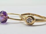 two gold rings with amethorate and diamonds on them