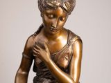 bronze statue of a woman with a flower in her hand