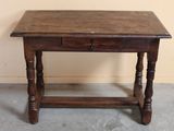 a small wooden table with a drawer on top of it