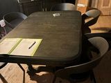 a table with a bunch of chairs around it in a room