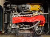 a tool box with a drill, drill, and other tools in it