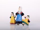 three figurines of a woman, a man and a child