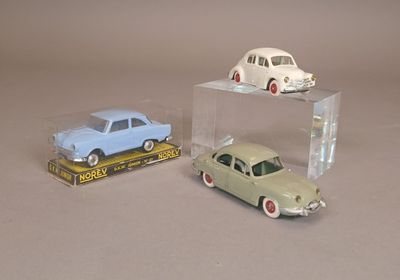 deux petites voitures dans une boîte transparente posée sur une table