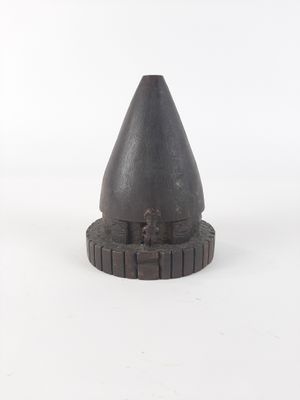 an image of a small metal cone on a white surface
