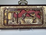 a gold and red box with a picture of a man and a woman on it