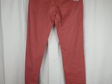 a pair of pink pants hanging on a white curtain