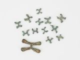 many small pieces of metal that are on a white surface
