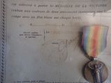 a medal and a ribbon on display in a glass case