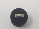 a close up of a diamond ring on a black ring holder