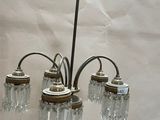 a chandelier that has five lights attached to it