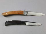 two knives that are sitting next to each other on a table