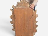 a man standing next to a piece of wood with a piece of wood sticking out of it
