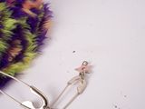 a pin with a pink star on it next to a purple and green scarf