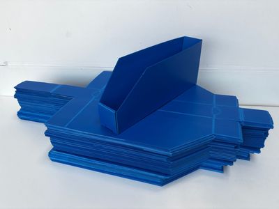 stack of blue folders sitting on top of each other on a white surface