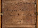 an old wooden box with writing on it sitting on top of a table