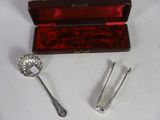 two silverware items in a red case on a table