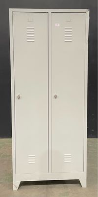 two white metal lockers sitting next to each other in a room