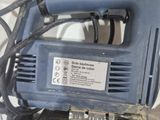 a blue electric tool that is sitting on top of a table