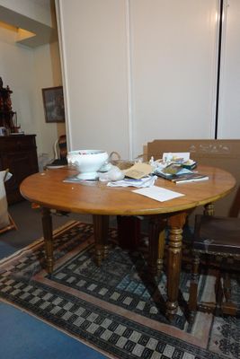 a table and chairs in a room with a rug on the floor