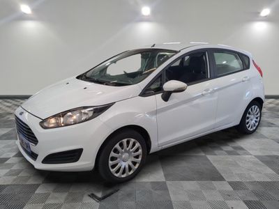a white ford fiesta parked on a checkered tile floor