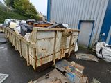 a dumpster full of garbage outside of a building