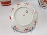 a white plate with red flowers on it on a table
