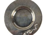 a silver plate with a lizard on it on a white background
