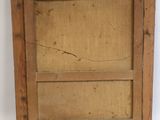 an old wooden picture frame sitting on top of a white wall