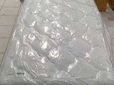 a mattress sitting on top of a box in a store