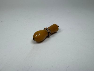 a small yellow object on a white surface