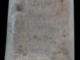 an old glass bottle with writing on it on a black background