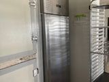 an image of a commercial kitchen with a stainless steel refrigerator