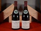 two bottles of wine sitting next to each other on a table