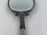 a mirror that is sitting on a white surface