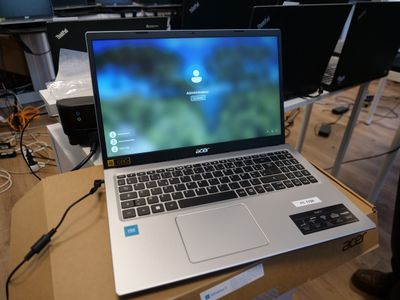 a laptop computer sitting on top of a cardboard box on a table