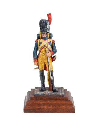 statue of a soldier in uniform with a sword on a wooden base