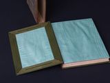an open book sitting on top of a table next to a picture frame