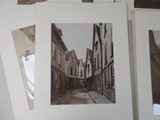 several black and white photos of a narrow street in an old town