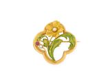 un gros plan d'une broche en forme de fleur jaune sur fond blanc