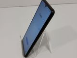 the back of a black cell phone sitting on top of a white table